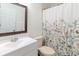 Well-lit bathroom with a floral curtain and vanity with ample counter space at 4030 Cortez Dr # C, Tampa, FL 33614