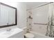 Clean bathroom featuring tiled shower/tub combo with safety grab bars at 4030 Cortez Dr # C, Tampa, FL 33614