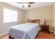 Cozy bedroom with wood floors, ceiling fan, and natural light from a bright window at 4030 Cortez Dr # C, Tampa, FL 33614