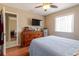 Comfortable bedroom featuring wood floors, a window, and a mounted television at 4030 Cortez Dr # C, Tampa, FL 33614