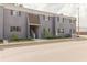 Two story exterior of an apartment with gray walls and brown shutters, fronted by tidy landscaping at 4030 Cortez Dr # C, Tampa, FL 33614