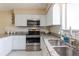 Kitchen features stainless steel appliances, white cabinets, and granite countertops at 4030 Cortez Dr # C, Tampa, FL 33614