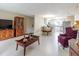 Bright living room with tile floors, a dining area, and a glimpse into the kitchen, offering an open-concept layout at 4030 Cortez Dr # C, Tampa, FL 33614