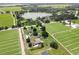 Aerial view of the home surrounded by farms, and a beautiful lake in the distance at 4030 Moores Lake Rd, Dover, FL 33527