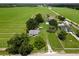 Aerial view of the property with lush fields and landscaping, highlighting the house and surrounding area at 4030 Moores Lake Rd, Dover, FL 33527