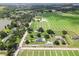 The home surrounded by farms, showing the expansive property and pond with lush landscaping at 4030 Moores Lake Rd, Dover, FL 33527