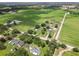Aerial view of the property showcasing the house, surrounding farms, and neighborhood layout at 4030 Moores Lake Rd, Dover, FL 33527