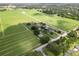 Unique aerial perspective showcasing a house surrounded by farmland and lush greenery at 4030 Moores Lake Rd, Dover, FL 33527