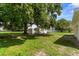 Large backyard featuring mature trees, a storage shed, and a well-maintained lawn at 4030 Moores Lake Rd, Dover, FL 33527