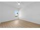 Simple bedroom with wood floors, ceiling fan, and natural light from window at 4030 Moores Lake Rd, Dover, FL 33527