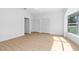 Bright bedroom with wood floors, large windows, and closet space at 4030 Moores Lake Rd, Dover, FL 33527