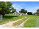 A charming single-story home with a lush green lawn, a long driveway and beautiful trees, highlighting the property's curb appeal at 4030 Moores Lake Rd, Dover, FL 33527