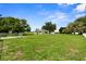 Spacious front yard with a white ranch style home, mature trees, a fenced yard, and open space at 4030 Moores Lake Rd, Dover, FL 33527