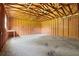 Unfinished garage interior showing wood framing, concrete floor, workbench and exposed ceiling at 4030 Moores Lake Rd, Dover, FL 33527
