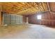 Spacious garage interior features plywood framing, a concrete floor, and garage door to backyard at 4030 Moores Lake Rd, Dover, FL 33527