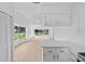 Bright living room featuring wood floors and large windows that provide lots of natural light and views of the outdoors at 4030 Moores Lake Rd, Dover, FL 33527