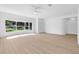 Bright living room featuring hardwood floors, a ceiling fan and lots of windows for natural light at 4030 Moores Lake Rd, Dover, FL 33527