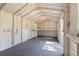 Spacious shed interior features built-in shelving, plywood walls, and overhead lighting fixtures at 4030 Moores Lake Rd, Dover, FL 33527