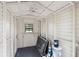 Shed interior with shelving, a window, and space for storage, all painted in a clean white color at 4030 Moores Lake Rd, Dover, FL 33527