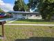 Charming single-story home with a well-maintained lawn and covered parking at 4104 W Wisconsin Ave, Tampa, FL 33616