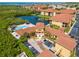 Aerial view showcasing the community, serene pond with fountain, visitor parking spots and landscaping at 4306 Bayside Village Dr # 201, Tampa, FL 33615
