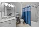 Bathroom featuring a shower-tub combo, granite counters and a large mirror at 4306 Bayside Village Dr # 201, Tampa, FL 33615