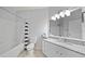 Clean bathroom featuring a shower-tub combo, granite counters and a large mirror at 4306 Bayside Village Dr # 201, Tampa, FL 33615