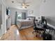 Bedroom featuring a ceiling fan, hardwood floors, with an ensuite bathroom, and a workspace at 4306 Bayside Village Dr # 201, Tampa, FL 33615