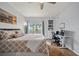 Cozy bedroom featuring a ceiling fan, a workspace, and a window view at 4306 Bayside Village Dr # 201, Tampa, FL 33615
