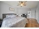 Bedroom featuring a ceiling fan, hardwood floors, with an ensuite bathroom, and a workspace at 4306 Bayside Village Dr # 201, Tampa, FL 33615