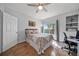 Bedroom featuring a large bed, a window with palm tree views, and a built-in bookcase at 4306 Bayside Village Dr # 201, Tampa, FL 33615