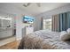 Bedroom features a ceiling fan, hardwood floors, ensuite bathroom, and a TV at 4306 Bayside Village Dr # 201, Tampa, FL 33615