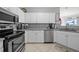 Modern kitchen featuring white cabinets and stainless steel appliances at 4306 Bayside Village Dr # 201, Tampa, FL 33615