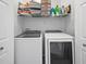 Laundry room features modern washer and dryer units and storage at 4306 Bayside Village Dr # 201, Tampa, FL 33615