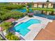 Overhead shot of the community pool with a cabana, lounge chairs and pristine landscaping at 4306 Bayside Village Dr # 201, Tampa, FL 33615