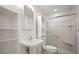 Modern bathroom with glass door shower, white sink, and built-in storage shelves at 4325 Aegean Dr # 250B, Tampa, FL 33611