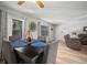 Inviting dining area features a dark wood table set for four, with a ceiling fan and lovely window views at 4325 Aegean Dr # 250B, Tampa, FL 33611