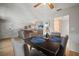 The dining area shows table settings for four, seamlessly flowing into a well-lit living space with a TV at 4325 Aegean Dr # 250B, Tampa, FL 33611
