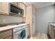Efficient kitchen layout with white appliances and light-colored cabinetry, ensuring a clean aesthetic at 4325 Aegean Dr # 250B, Tampa, FL 33611