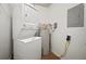 A laundry room with stacked washer and dryer, plus a water heater, providing functionality and convenience at 4325 Aegean Dr # 250B, Tampa, FL 33611