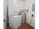 Compact laundry room with stacked washer and dryer unit, and water heater, maximizing space efficiency at 4325 Aegean Dr # 250B, Tampa, FL 33611