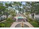 Beautiful pool area surrounded by mature trees, lounge chairs and a clubhouse at this wonderful community at 4325 Aegean Dr # 250B, Tampa, FL 33611