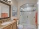 Bathroom with a vanity, granite countertop, and tiled walk-in shower at 4335 Clairidge Way, Palm Harbor, FL 34685