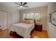 Bedroom with wood floors, ceiling fan, window with shutters, and a queen bed at 4335 Clairidge Way, Palm Harbor, FL 34685