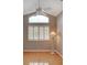 Bedroom featuring light hardwood floors, and a window with plantation shutters at 4335 Clairidge Way, Palm Harbor, FL 34685