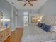 Bright bedroom featuring hardwood floors, a plush bed, and a view towards the bathroom at 4335 Clairidge Way, Palm Harbor, FL 34685