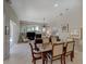 Open-concept dining and living room boasts natural light, fireplace, and elegant furnishings at 4335 Clairidge Way, Palm Harbor, FL 34685