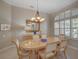 Bright dining room with large windows and a stylish chandelier at 4335 Clairidge Way, Palm Harbor, FL 34685