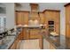 Spacious kitchen featuring dark countertops, a cooktop, and stainless steel appliances at 4335 Clairidge Way, Palm Harbor, FL 34685