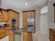 Gourmet kitchen island featuring granite countertop and stainless steel appliances at 4335 Clairidge Way, Palm Harbor, FL 34685